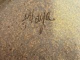 a close up of a large brown pot with writing on it