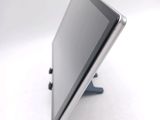 a tablet computer sitting on a stand on a white surface