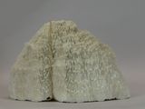 two white rocks sitting on top of a white surface