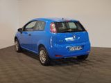 the small blue car is parked in a room with a checkered floor