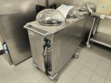 a large stainless steel counter with a bunch of food items on it
