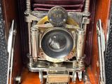 an old camera that is sitting in a wooden box