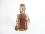 a small statue of a person sitting on a white surface