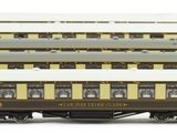 several brown and white train cars sitting next to each other on a white surface