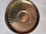 a gold plate with a circular design on it