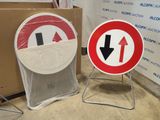 two signs sitting next to each other in a room