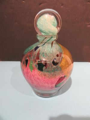 a glass vase with a colorful design on it on a table