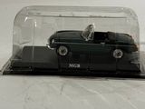 a black car in a glass case on a white surface