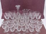 a lot of wine glasses and a pitcher on the table