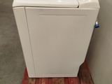 a white washing machine sitting on a pallet in a warehouse