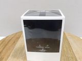 the box is empty on a wooden table with a white wall in the background