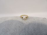 an image of a pearl ring sitting on top of a stone