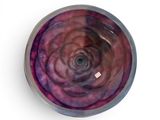 a purple bowl with a pink swirl inside of it