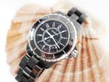 a close up of a watch on a seashell