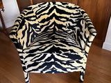 a zebra print chair in the corner of a living room