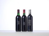 three bottles of wine are lined up on a table