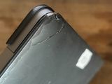 a close up of a cell phone with a cracked screen
