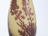 a yellow vase with a brown and white design on it