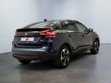 the rear end of a black car in a room