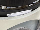 a close up of a car ' s tire with a sticker on it