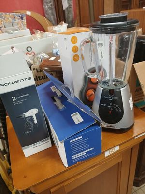 a blender sitting on top of a wooden table next to a box