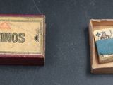 a box of dominos next to a box of matches
