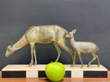 a statue of a deer and a baby deer on a table