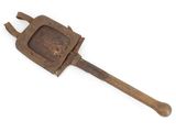 an old rusty tool with a wooden handle on a white surface