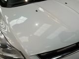 a white car that is parked in a showroom
