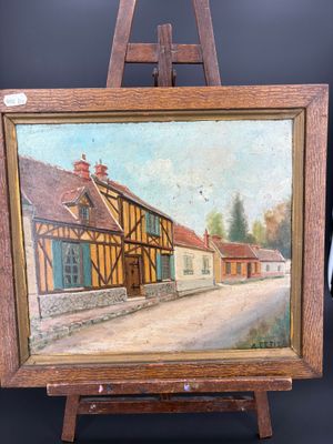 an oil painting of a village scene on a wooden easel