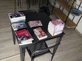 a black table with books on it in the middle of a room