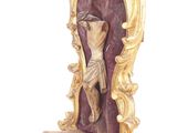 a figurine of a woman holding a bird on top of a stand