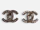 a pair of chanel earrings with crystals on them