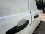 a white van that is parked on the side of the road