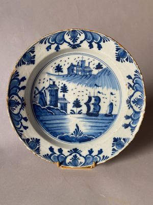 an old blue and white plate with a picture of a castle on it
