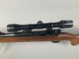 a rifle with a scope mounted on top of it