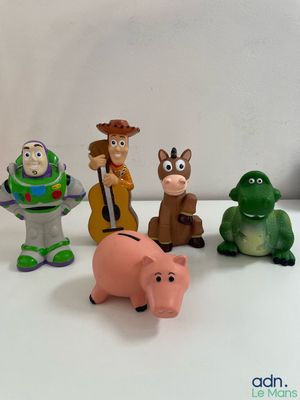 toy figurines of various characters are arranged on a white surface