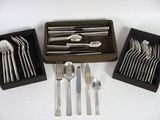 a box of silverware and a tray of forks and spoons