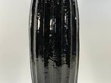 a black vase that is sitting on a table