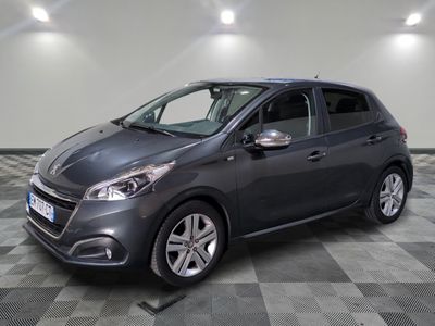 the grey car is parked on a checkered floor in the garage