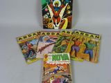 a group of comic books sitting on top of a white table