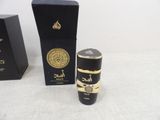 a close up of a bottle of perfume next to a box