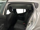 the back seats of a car with the door open in a parking lot