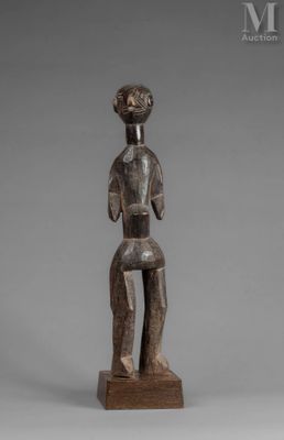 a wooden statue of a man with a hat on his head