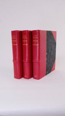 three red books sitting on top of each other on a white surface