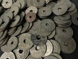 a pile of old coins sitting on a table
