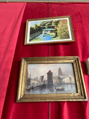 deux photos encadrées posées sur une table rouge recouverte d'une nappe rouge