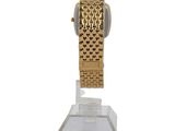 an image of a gold watch on a clear stand on a white background