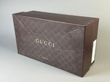a brown box with the word gucci written on it