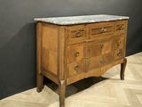 a marble top chest of drawers on a parquet floor